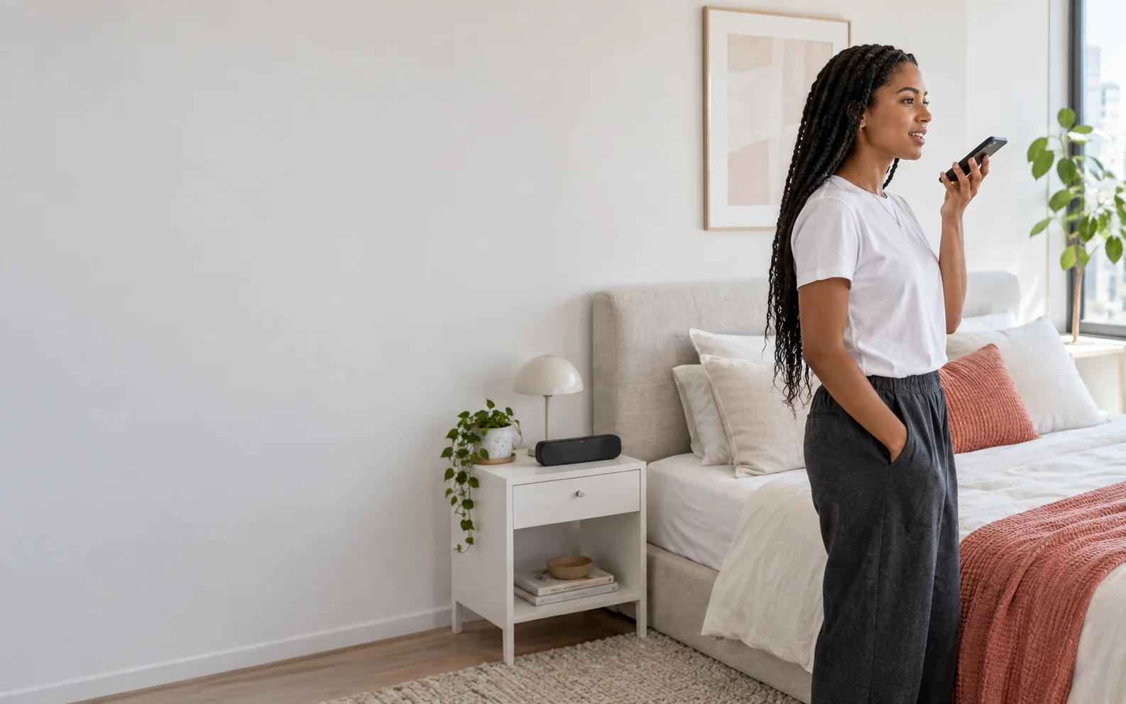 A person speaking to their phone in a contemporary home